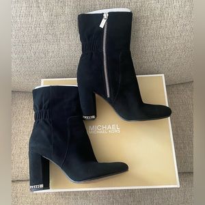 Michael Kors feature block heel accented with metallic chain and logo detailing